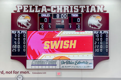 Traditional scoreboard paired with a videoboard in a gymnasium